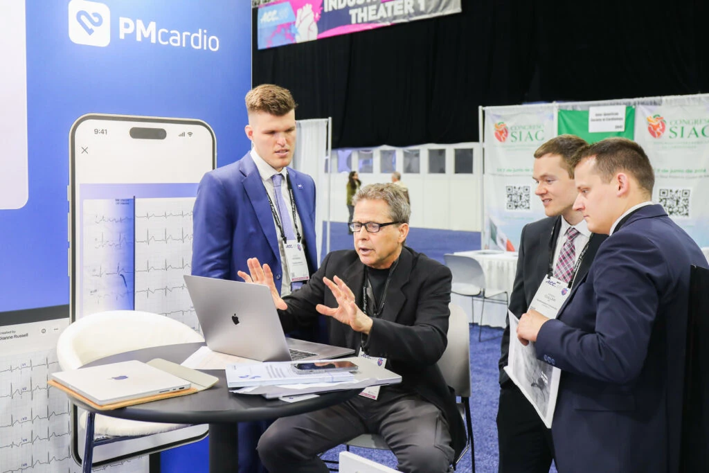 Powerful Medical team demonstrating PMcardio to a cardiologist at the ACC 2024 booth