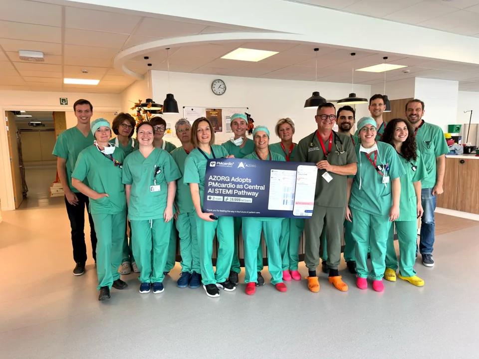 Heart Center Aalst clinical team in scrubs holding a banner marking AZORG adopting PMcardio as its AI STEMI pathway