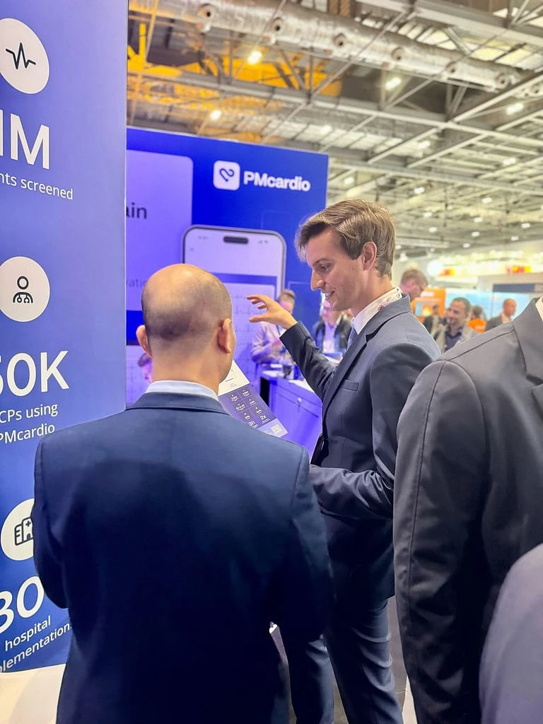 PMcardio team member demonstrating the ECG app to an attendee at ESC Congress 2024