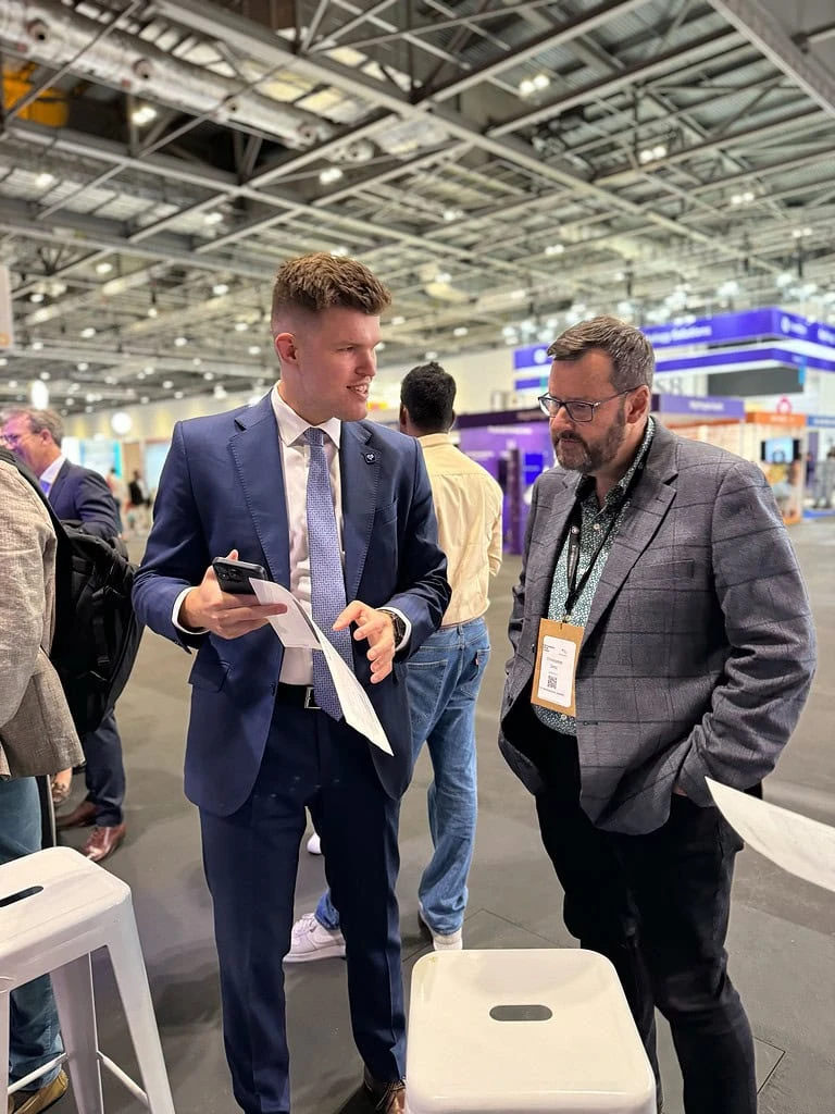 Powerful Medical team member showing PMcardio ECG results on a phone at ESC Congress 2024