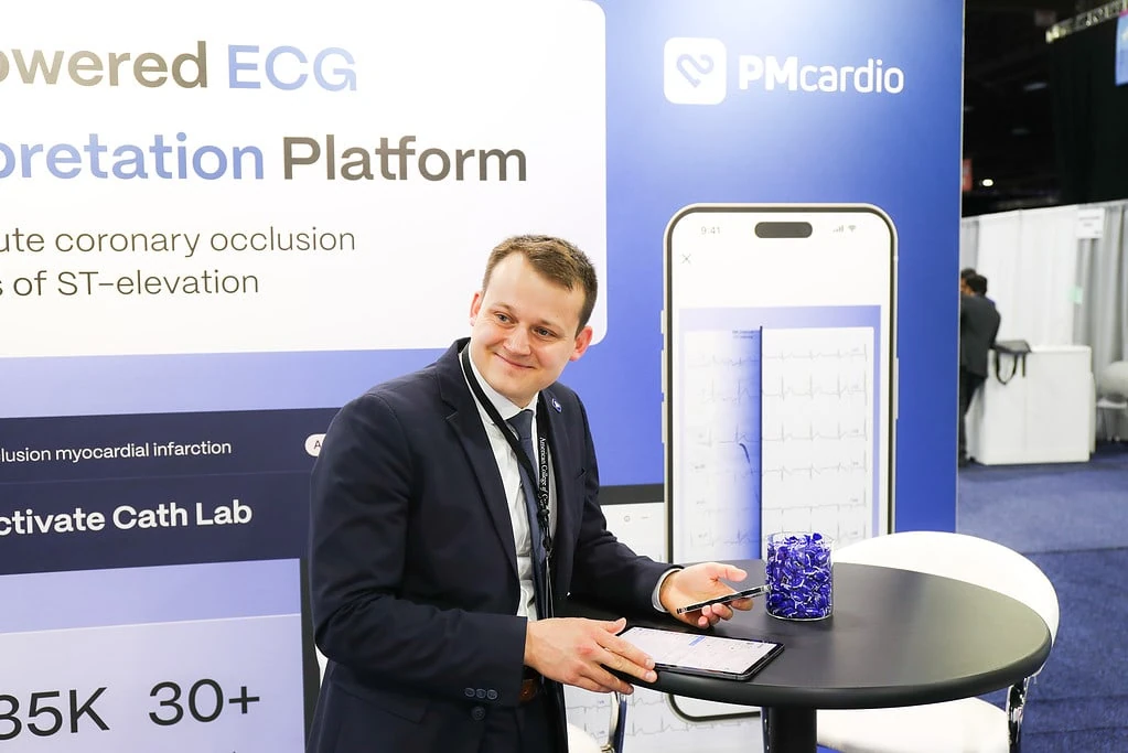 Powerful Medical team member demoing PMcardio AI ECG interpretation on a tablet at the ACC.24 booth