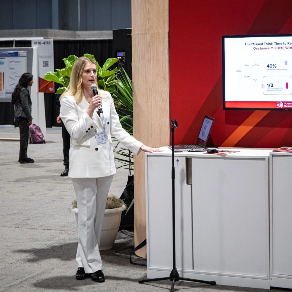 Dr. Timea Kisova presenting occlusive MI research at the Powerful Medical AHA 2024 poster station