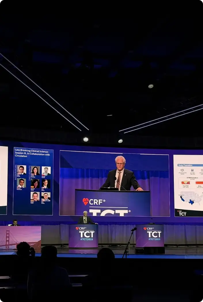 Speaker on stage presenting the AI-based ECG analysis study at an ACC session