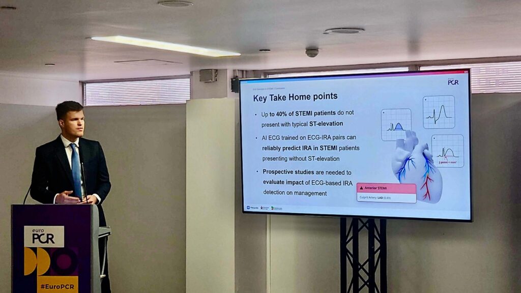 May Highlights from Powerful Medical: PMcardio 3.0 Launch, STEMI Research, and Clinical Breakthroughs Dr. Robert Herman presenting ECG model feasibility results at EuroPCR, with a slide on IRA detection beyond STEMI criteria.